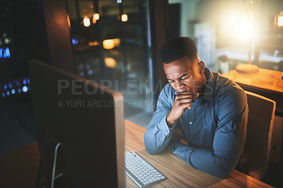 Buy stock photo Cropped shot of a young businessman yawning while working late at night in a modern office