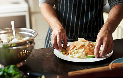 Buy stock photo Cropped shot of an unrecognizable young man preparing food in the kitchen at home