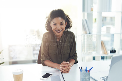 Buy stock photo Portrait of a confident young businesswoman sitting at her desk in a modern office