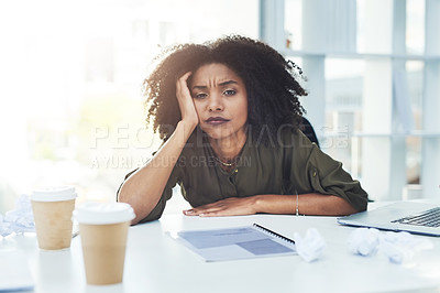 Buy stock photo Portrait of a young businesswoman sitting at her office desk looking tired and stressed out