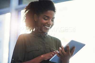 Buy stock photo Close up shot of a young businesswoman using her digital tablet in a office