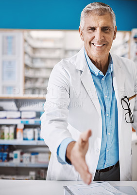Buy stock photo Shot of a pharmacist extending his arm for a handshake