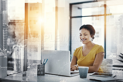 Buy stock photo Shot of a young designer working on a laptop in an office