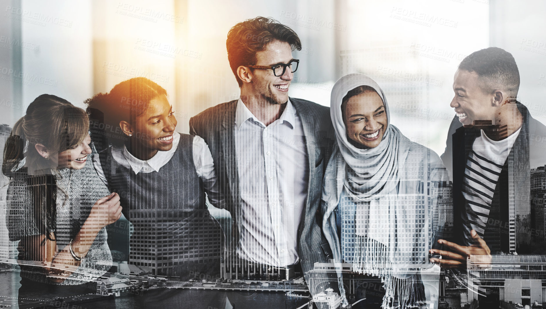 Buy stock photo Shot of a group of young cheerful businesspeople standing with arms around inside of the office at work during the day