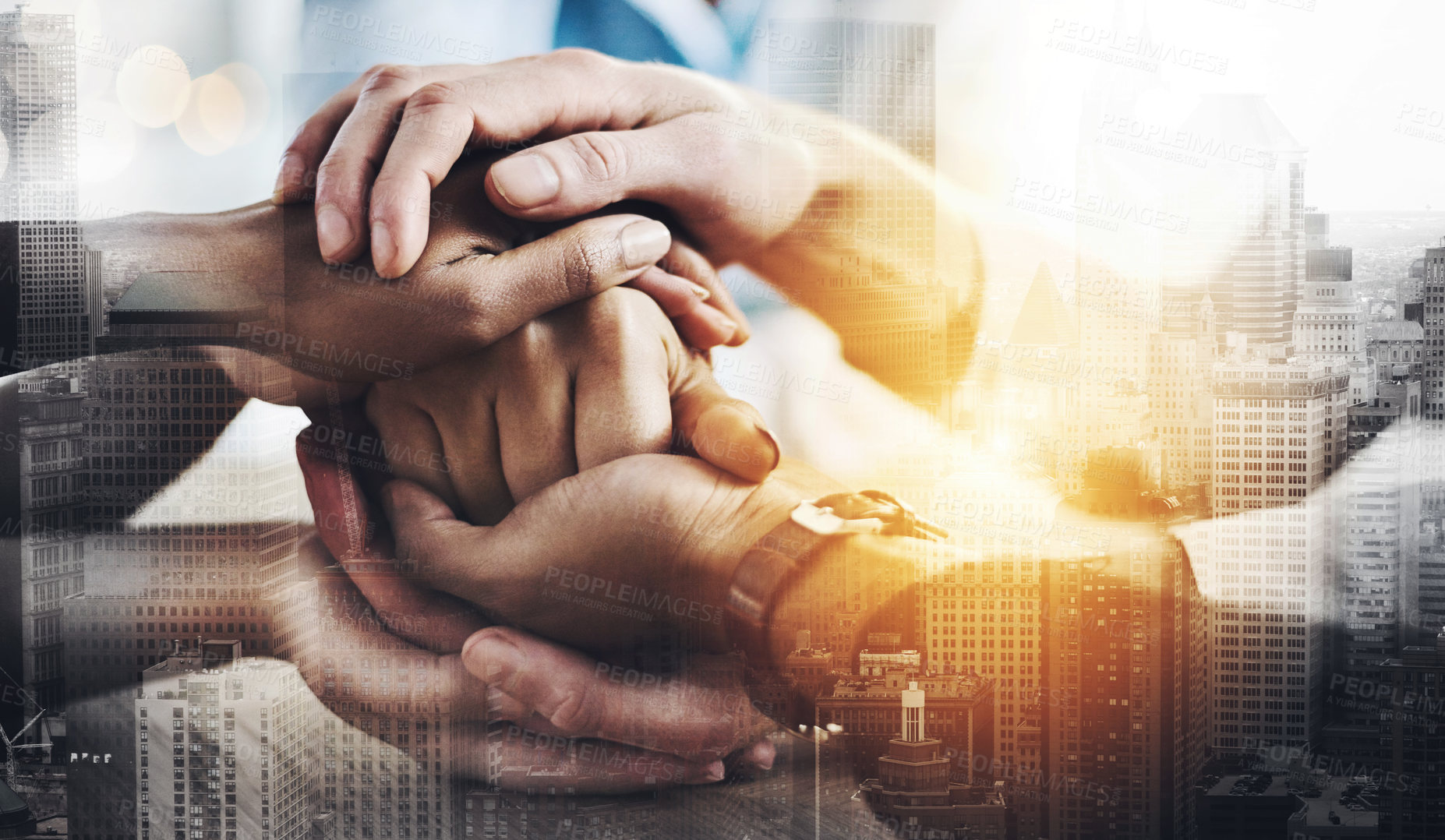 Buy stock photo Cropped shot of a group of unrecognizable businesspeople sitting in the boardroom with their hands in a huddle