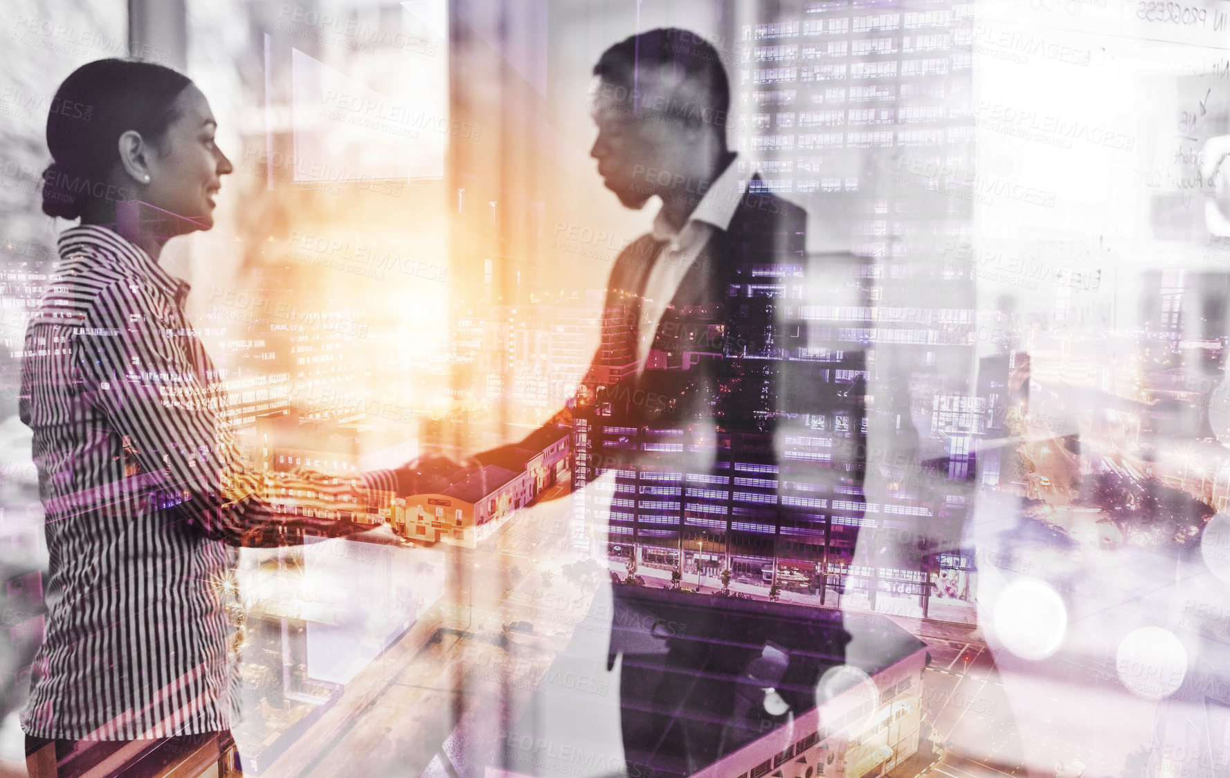 Buy stock photo Shot of two businesspeople shaking hands in an office