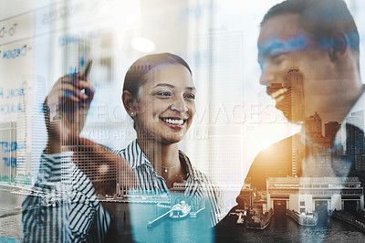 Buy stock photo Shot of two businesspeople brainstorming with notes on a glass wall in an office