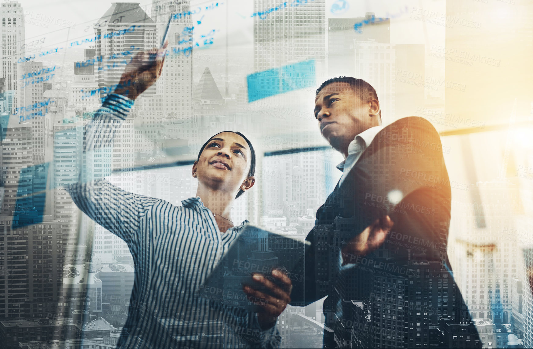 Buy stock photo Shot of two businesspeople brainstorming with notes on a glass wall in an office