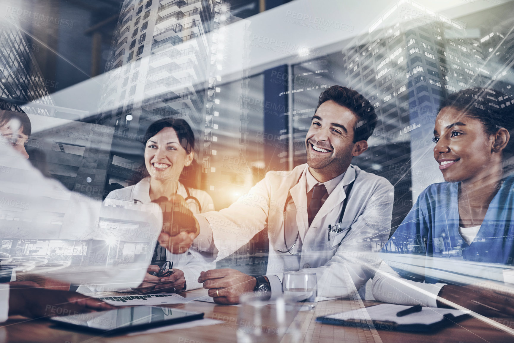 Buy stock photo Cropped shot of two doctors shaking hands during a meeting in a hospital