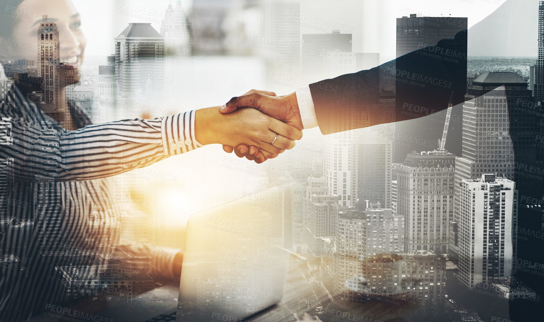 Buy stock photo Cropped shot of two businesspeople shaking hands in an office