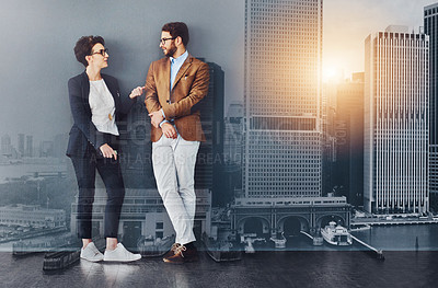 Buy stock photo Full length shot of two designers having a conversation while leaning against a wall