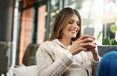 Buy stock photo Happy woman, relax and chatting with phone for social media, communication or browsing at home. Female person with smile on mobile smartphone for online texting, app or scrolling on living room sofa