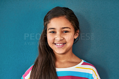 Buy stock photo Girl, child and portrait with smile in blue background, happiness for education in New York City. Female student, elementary grade and cheerful for knowledge in classroom, back to school in studio