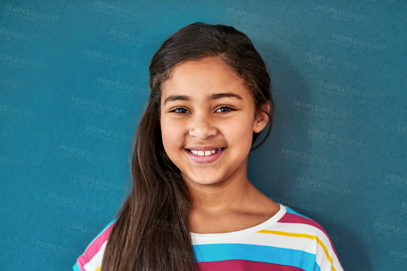 Buy stock photo Girl, child and portrait with smile in blue background, happiness for education in New York City. Female student, elementary grade and cheerful for knowledge in classroom, back to school in studio