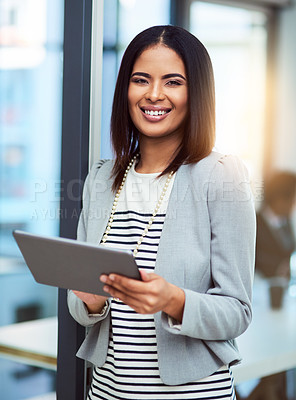 Buy stock photo Cropped shot of a beautiful young businesswoman using a tablet in the workplace