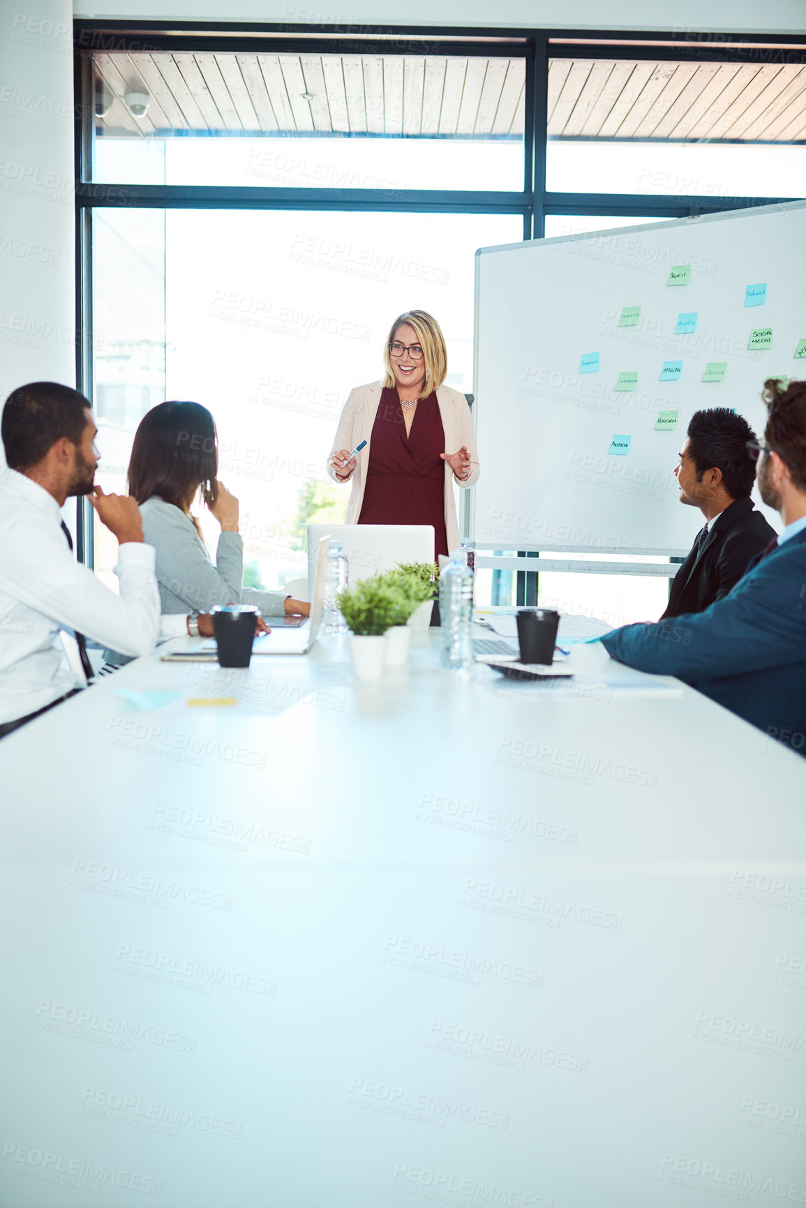 Buy stock photo Shot of corporate businesspeople having a meeting in the boardroom at work