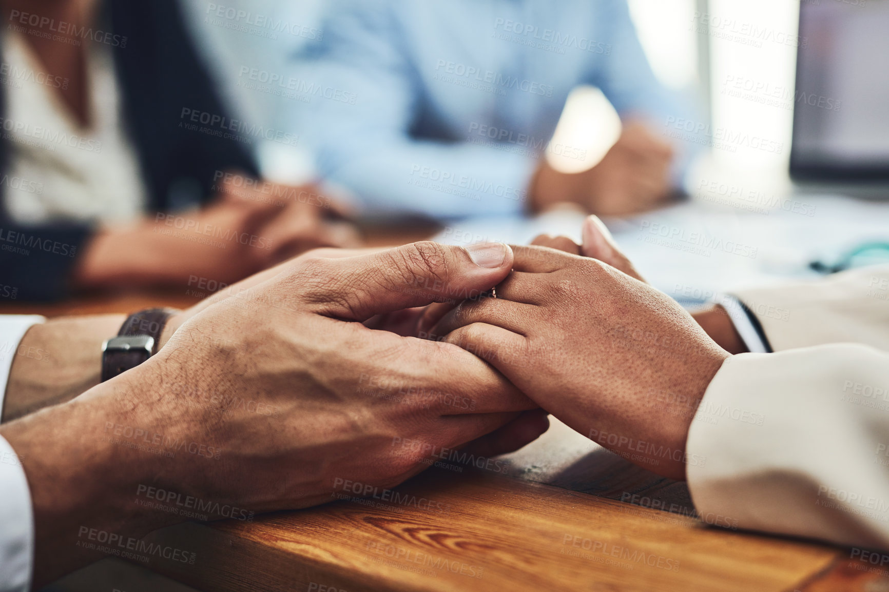 Buy stock photo Closeup of two unrecognizable people holding hands inside of the office during the day