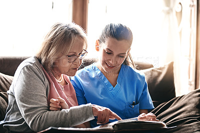 Buy stock photo Elderly, woman and nurse with photo album on couch for memories, nostalgia or remember with support. Senior, person or female caregiver in assisted living with talking of pictures, empathy or bonding