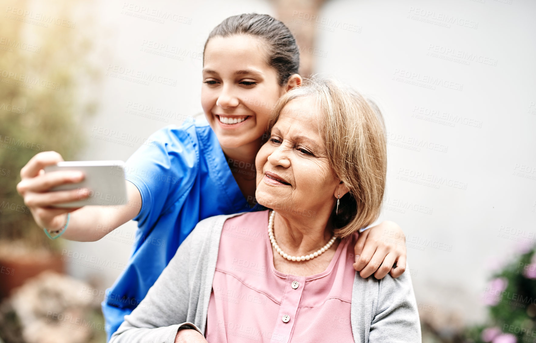 Buy stock photo Cropped shot of a caregiver taking a selfie with a senior patient outside