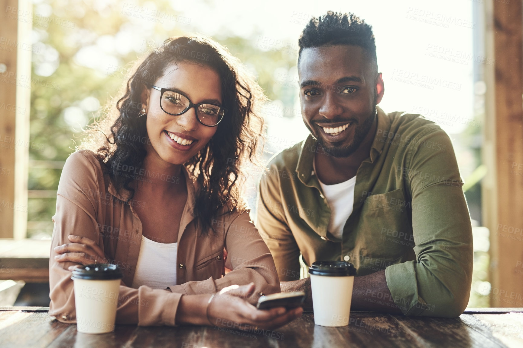 Buy stock photo Portrait, man and woman in cafe with phone, smile and connection for online dating relationship. Flirt, love and happy couple in coffee shop together on mobile app for contact, romance and networking