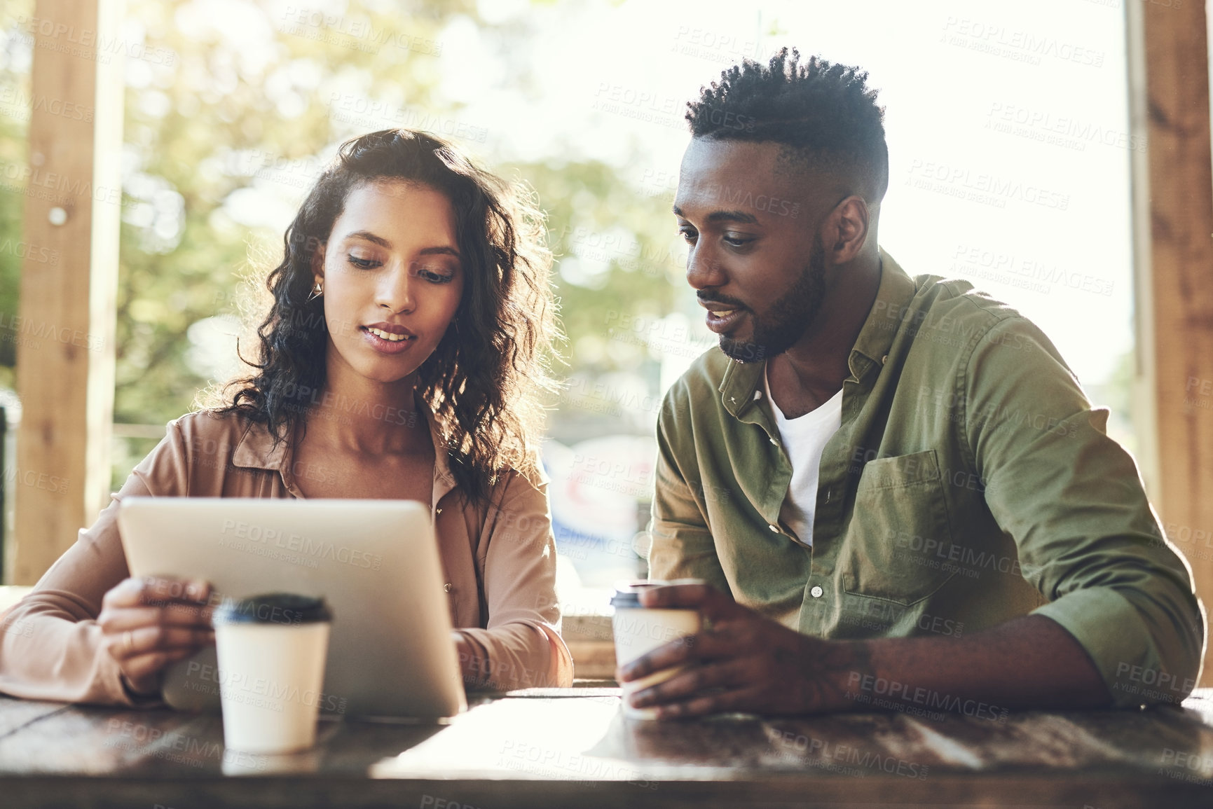 Buy stock photo Tablet, freelance and team meeting at cafe for startup, research or people at coffee shop. Technology, collaboration and partners on internet for networking, communication or planning at restaurant