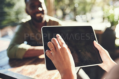 Buy stock photo Shot of a young man placing his order with a waiter using a digital tablet