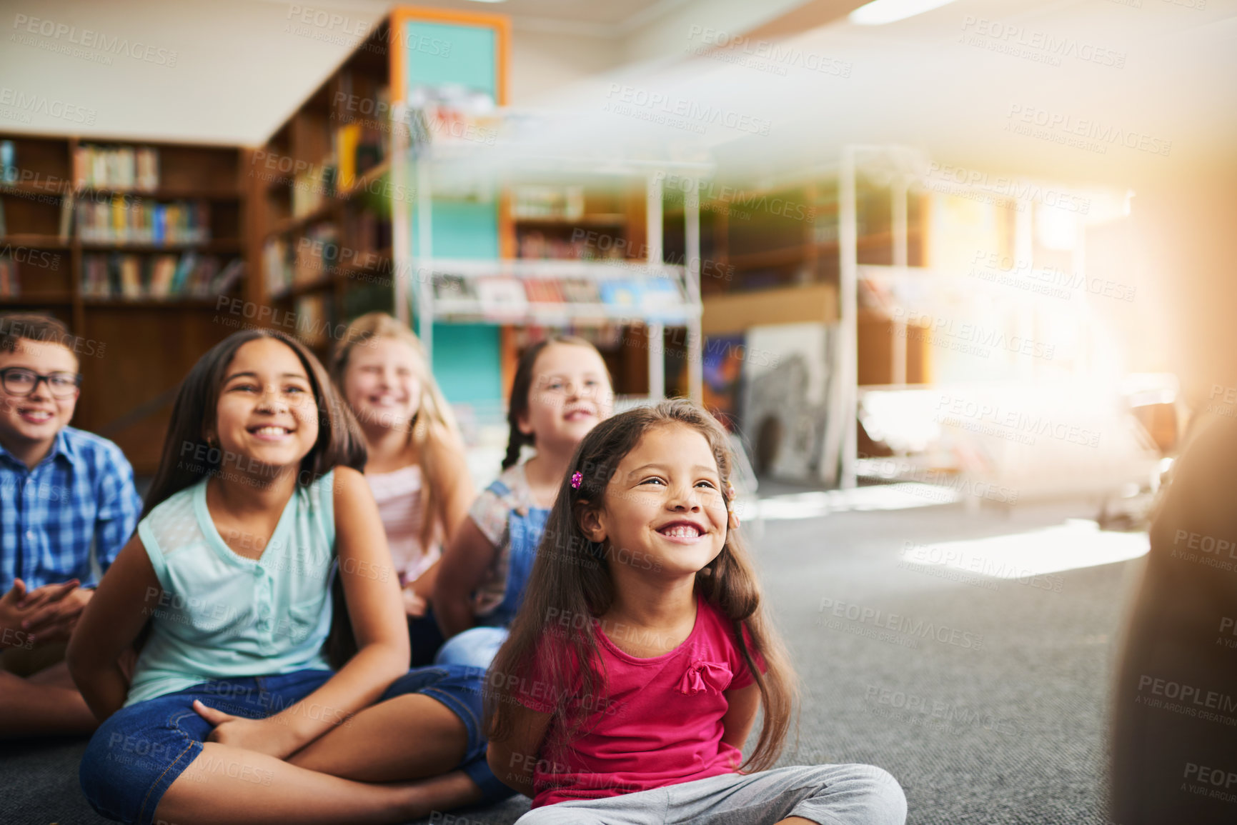 Buy stock photo Happy children, teacher and reading with book for lesson, learning or youth development in library. Young, group or kindergarten kids with smile for novel, storytelling or knowledge in literature