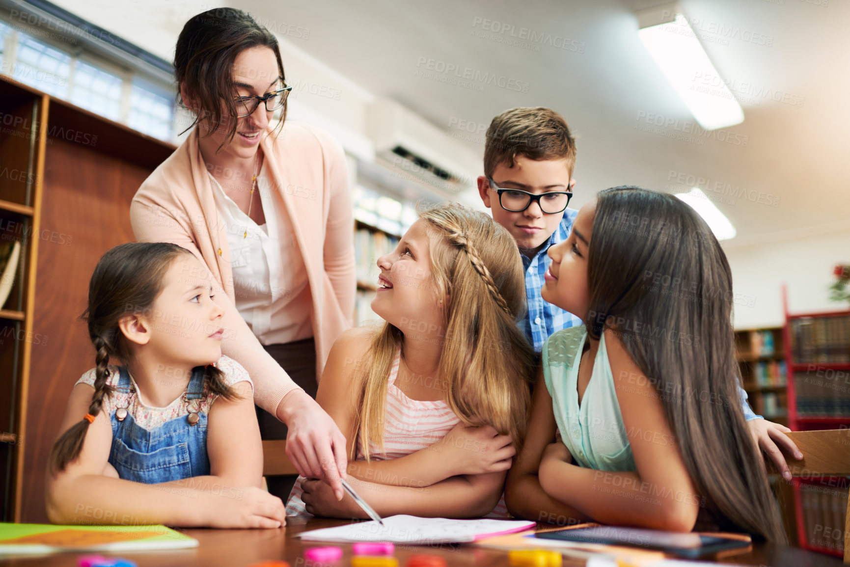 Buy stock photo Woman, kids or teaching students in library for education, child development or learning in junior grade together. Studying, primary school and group of children with teacher, tutor and assistance