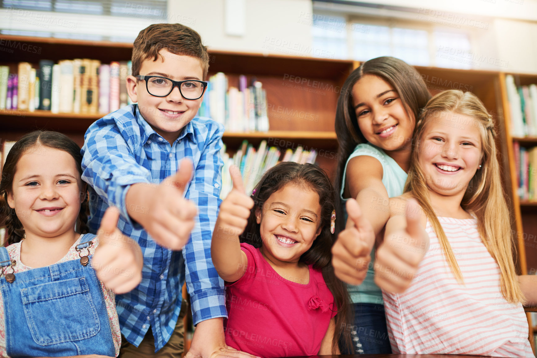 Buy stock photo Happy kids, portrait or students with thumbs up in library for review or feedback in learning or education. School, vote or group of proud children with like, yes sign or OK for agreement or teamwork