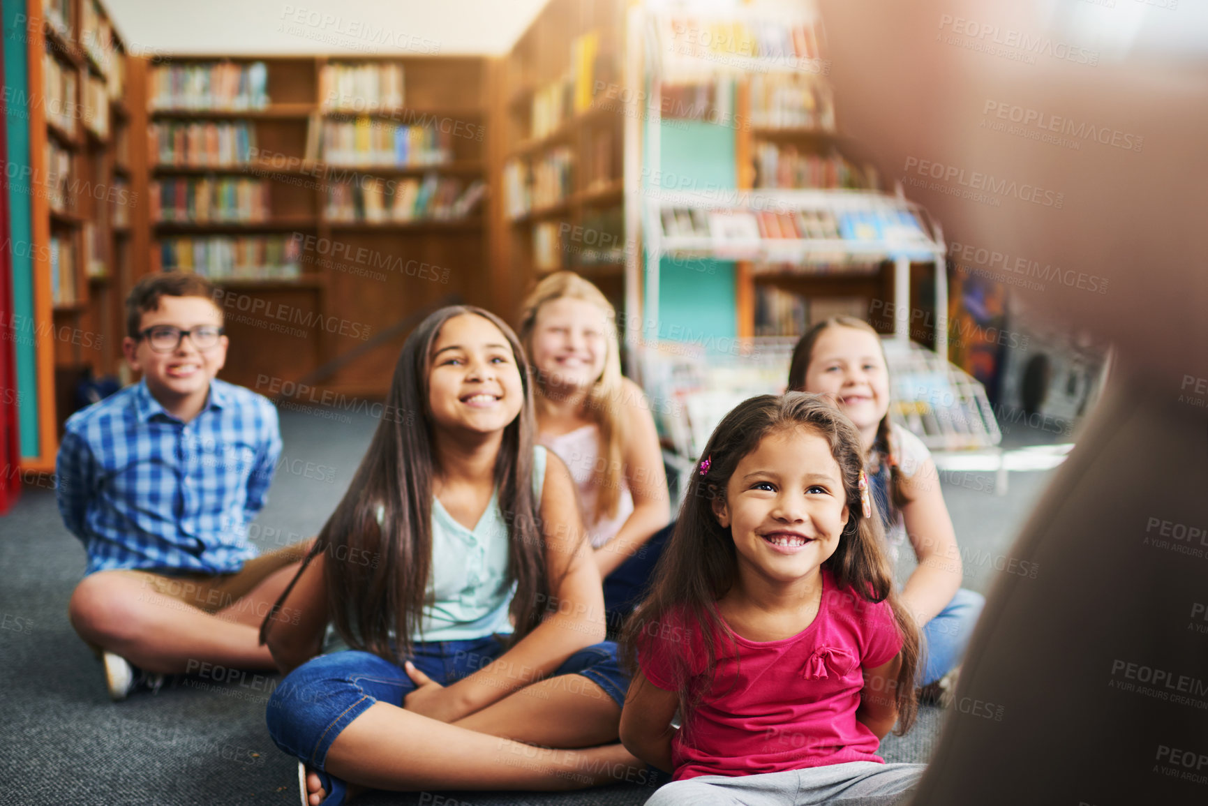 Buy stock photo Happy children, teacher and reading with story for lesson, learning or youth development in library. Young, group or kindergarten kids with smile for novel, storytelling or knowledge in literature