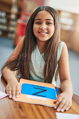 Buy stock photo Girl, happy and portrait in library for study, education and learning with childhood development. Student, book and excited in school for english reading, knowledge or academic information with smile