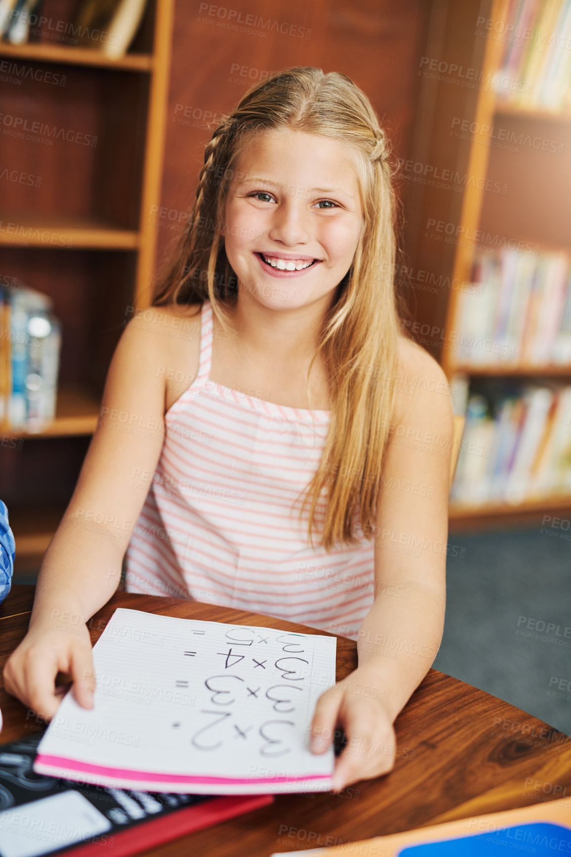 Buy stock photo Girl, happy and portrait in library for education, learning and study with childhood development. Student, book and excited in school for math knowledge, reading and academic information with smile