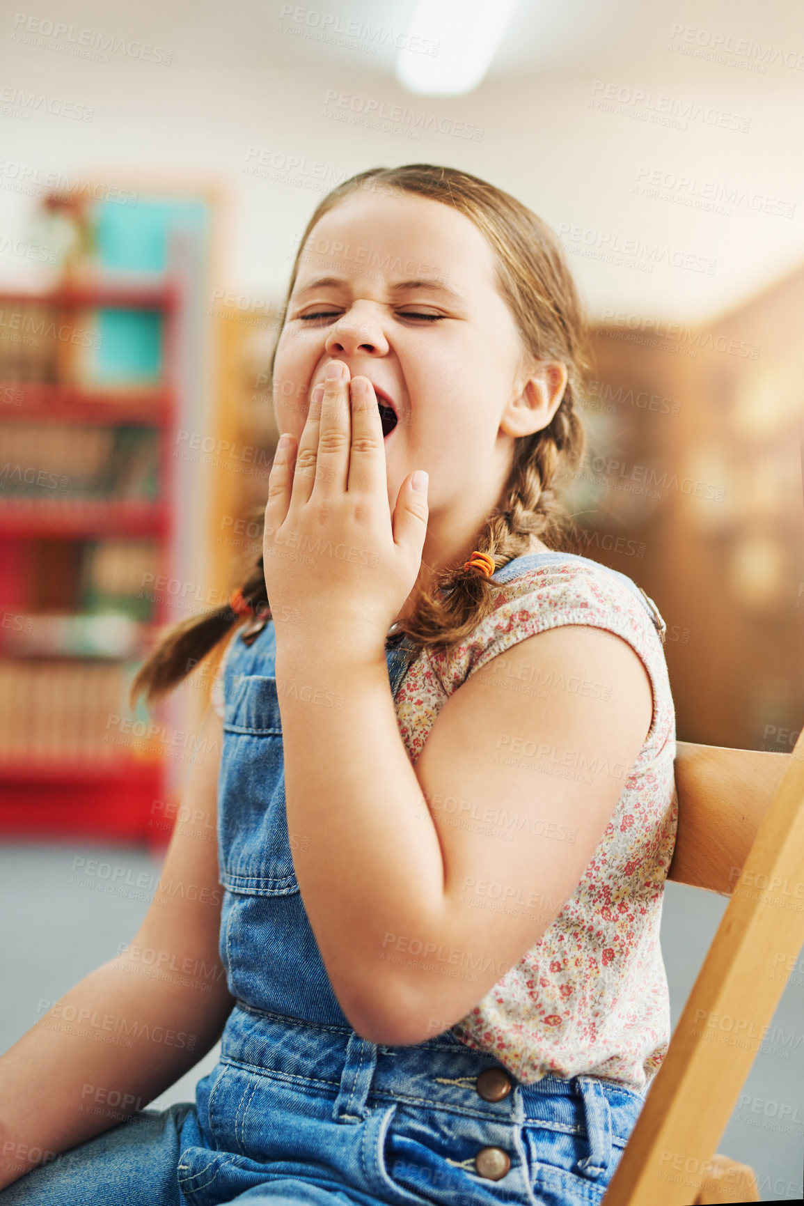 Buy stock photo Girl, child and yawning in classroom at school, tired and lazy for education, development and progress. Kid, fatigue and brain fog with scholarship, studying or exhausted at library with burnout