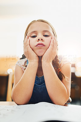 Buy stock photo Portrait of a young girl looking stressed while being seated inside of a classroom during the day