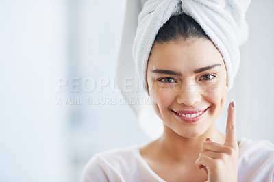 Buy stock photo Beauty, moisturizer and portrait of woman in bathroom of home for morning skincare routine. Cream, finger and lotion with happy person in towel at apartment for antiaging cosmetics or dermatology