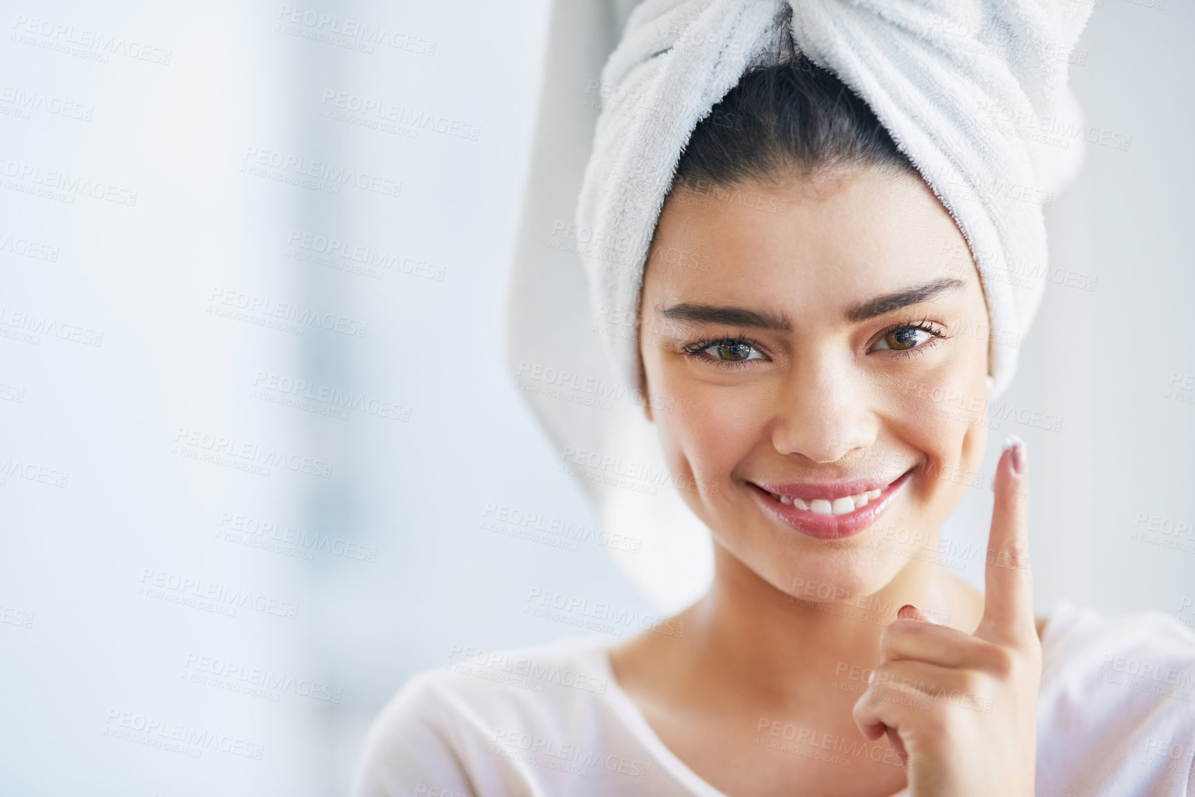 Buy stock photo Beauty, moisturizer and portrait of woman in bathroom of home for morning skincare routine. Cream, finger and lotion with happy person in towel at apartment for antiaging cosmetics or dermatology