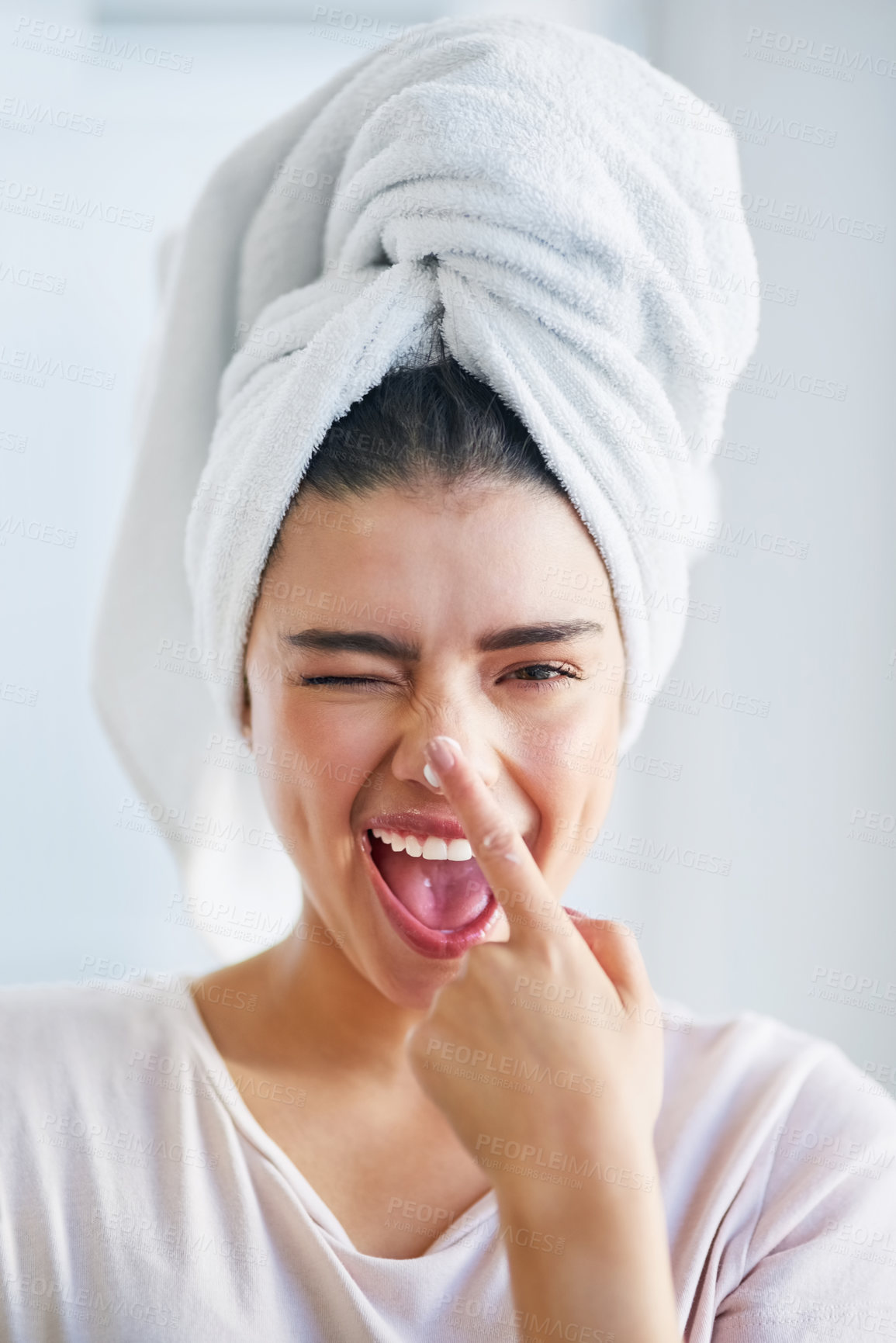 Buy stock photo Beauty, cream and portrait of woman winking in bathroom of home for morning skincare routine. Finger, lotion and nose with happy person for fun in towel at apartment for cosmetics or dermatology