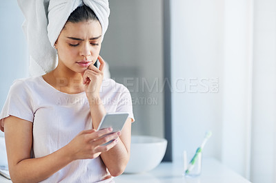 Buy stock photo Woman, stress and skincare with phone in bathroom for beauty treatment, mistake and facial research. Tech, thinking and person with anxiety at home for website, connection and online dermatology tips