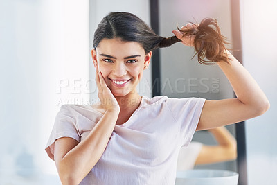 Buy stock photo Portrait of a beautiful young woman holding her hair in the bathroom at home