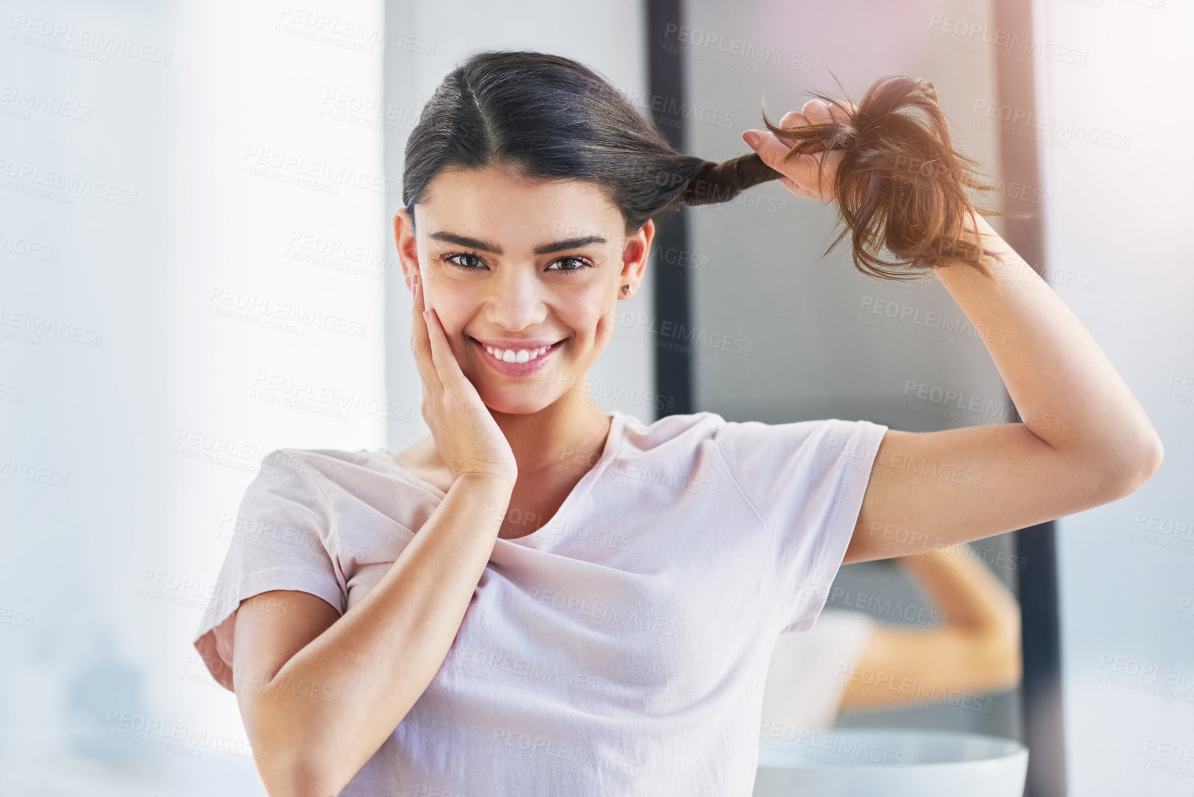Buy stock photo Portrait of a beautiful young woman holding her hair in the bathroom at home