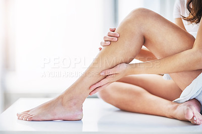 Buy stock photo Skincare, feeling and legs of a woman after waxing, grooming and cleaning in a bathroom. Beauty, moisturize and a person touching a leg after shaving or removing body hair for a treatment at home 