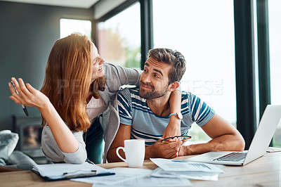 Buy stock photo Shot of an affectionate young couple working on their household budget