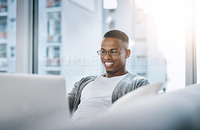 Buy stock photo Home, man and laptop working on sofa or elearning, remote study or distance learning and online studying with internet communication. Black student, happy on computer in apartment or living room 