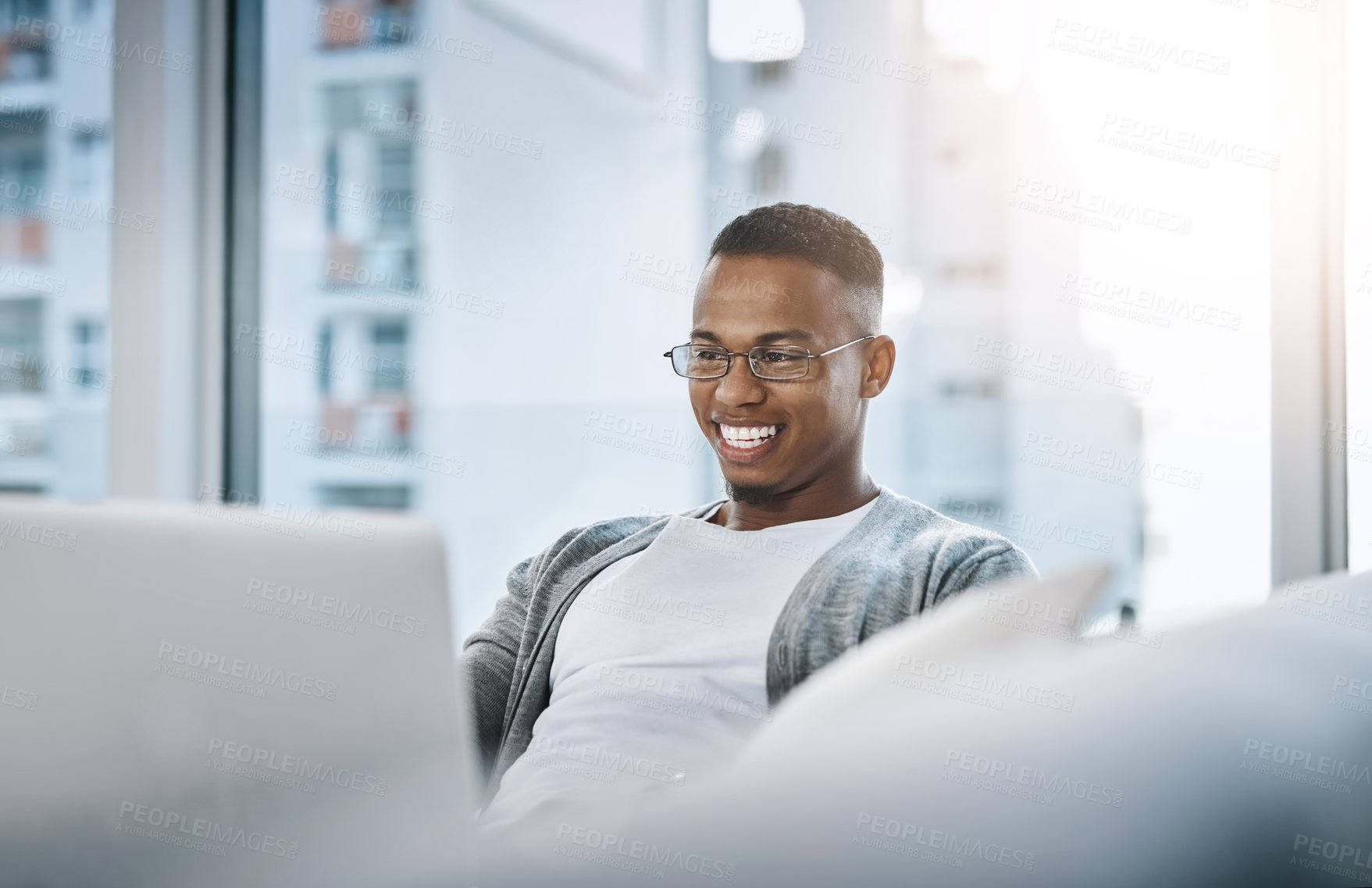 Buy stock photo Home, man and laptop working on sofa or elearning, remote study or distance learning and online studying with internet communication. Black student, happy on computer in apartment or living room 