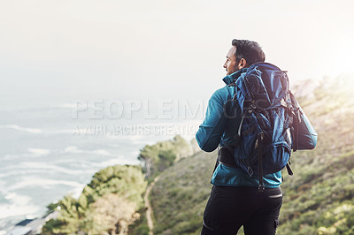 Buy stock photo Rearview shot of a middle aged man hiking in the mountains