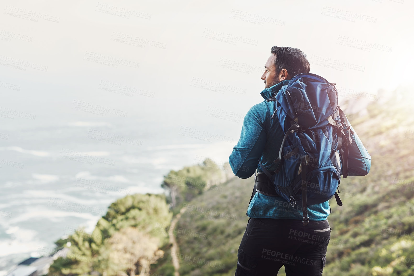 Buy stock photo Rearview shot of a middle aged man hiking in the mountains