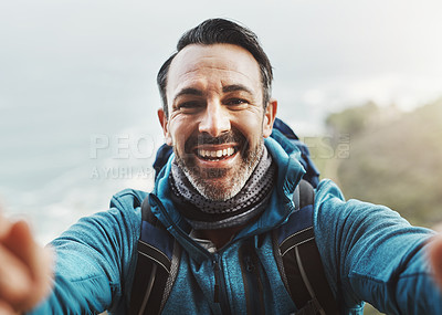 Buy stock photo Portrait of a middle aged man taking a selfie in the mountains