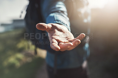 Buy stock photo Close up shot of an unrecognizable man reaching out his hand in the mountains