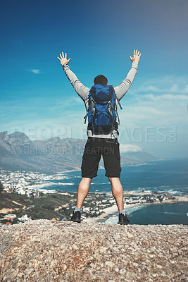 Buy stock photo Back, hike and man with celebration, outdoor and travel with blue sky, achievement and adventure. Rear view, person or hiker with environment, joy or ocean with summer, explore or journey with nature