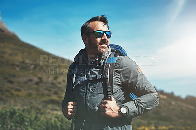 Buy stock photo Shot of a middle aged man hiking in the mountains